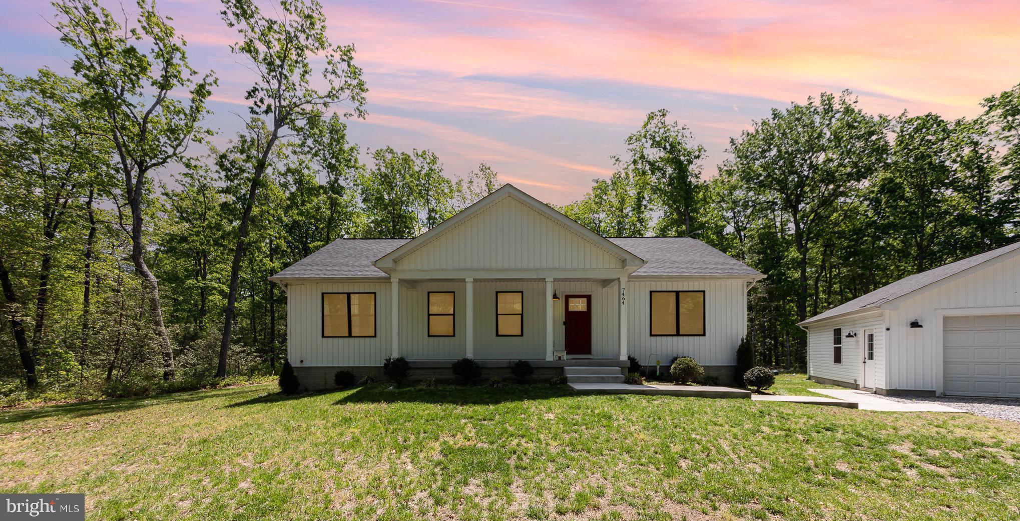 7464 Cedar Fork Road Ruther Glen, VA 22546 - Photo 1 of 24 a front view of house with yard and green space