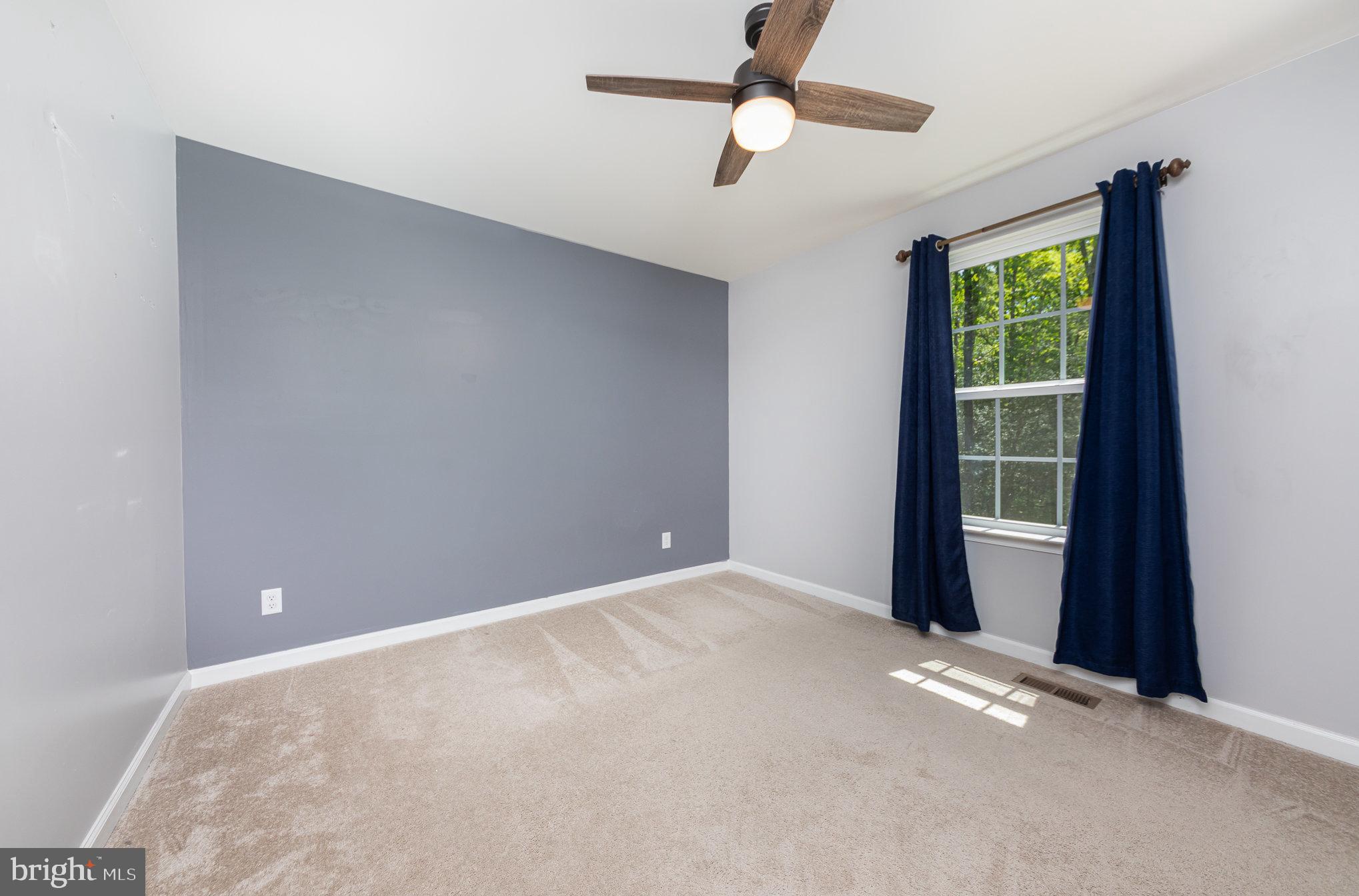 7464 Cedar Fork Road Ruther Glen, VA 22546 - Photo 11 of 24 an empty room with windows and fan