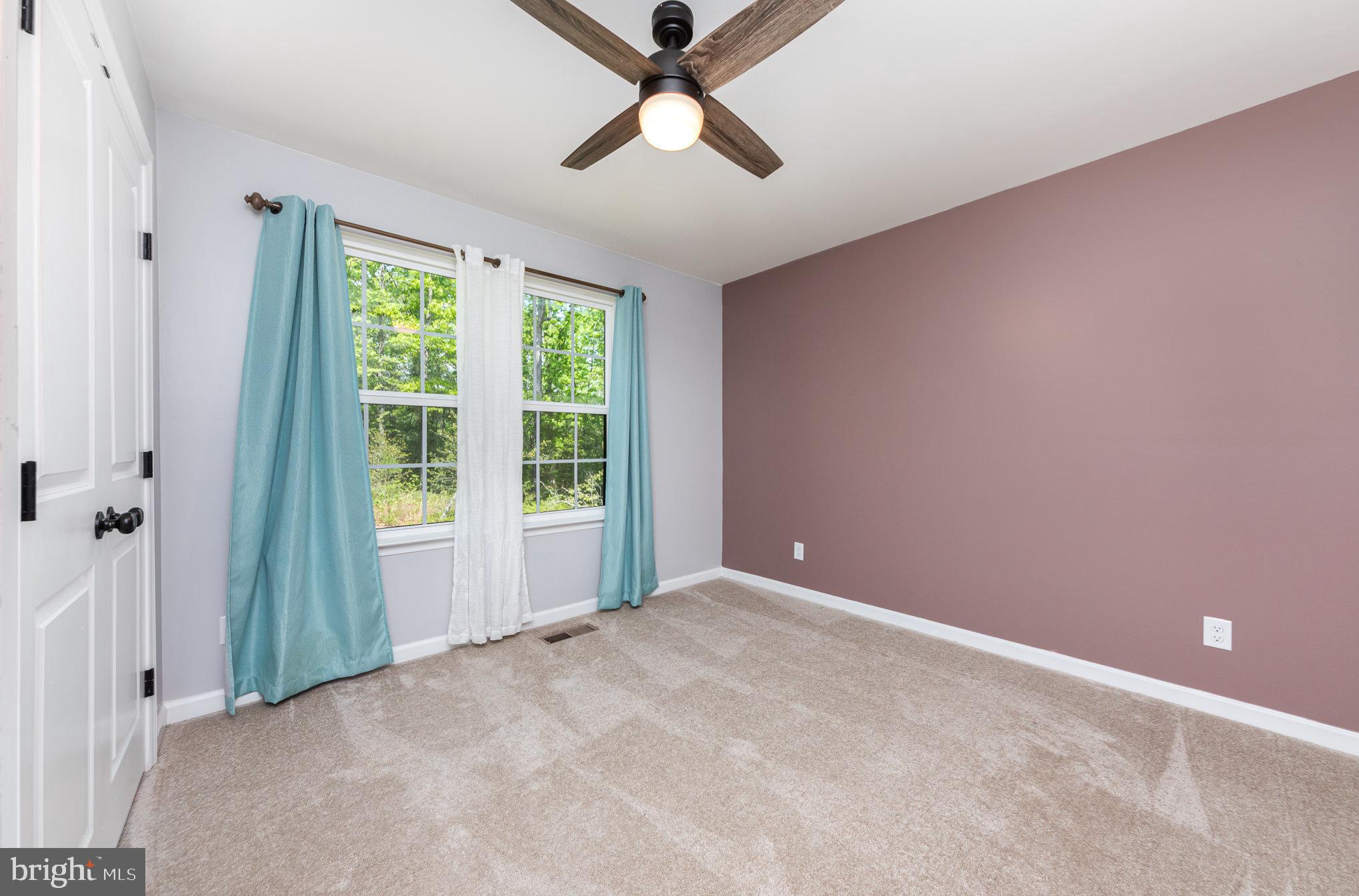 7464 Cedar Fork Road Ruther Glen, VA 22546 - Photo 12 of 24 a view of a livingroom with a ceiling fan and window