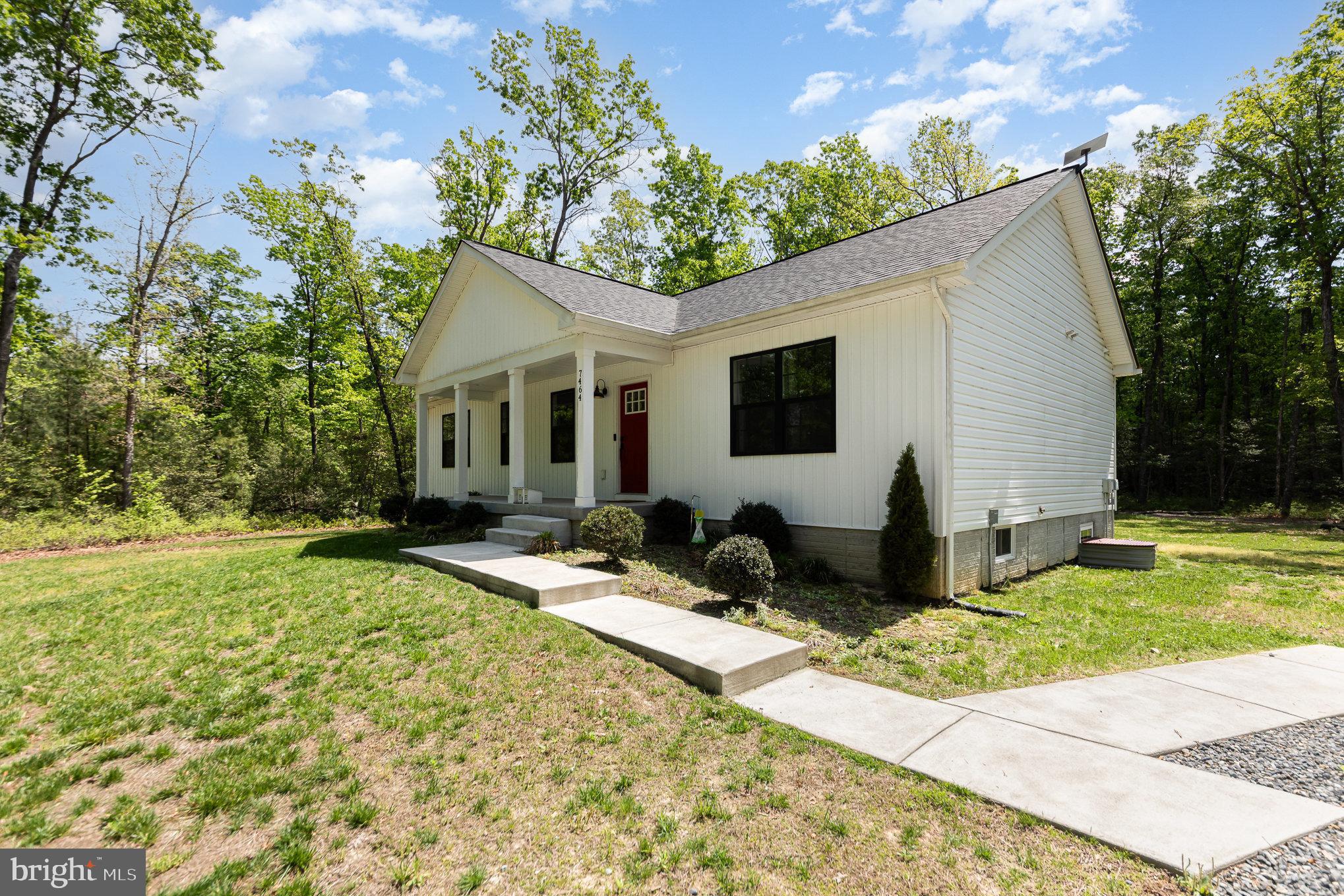 7464 Cedar Fork Road Ruther Glen, VA 22546 - Photo 3 of 24 a front view of house with yard patio and green space