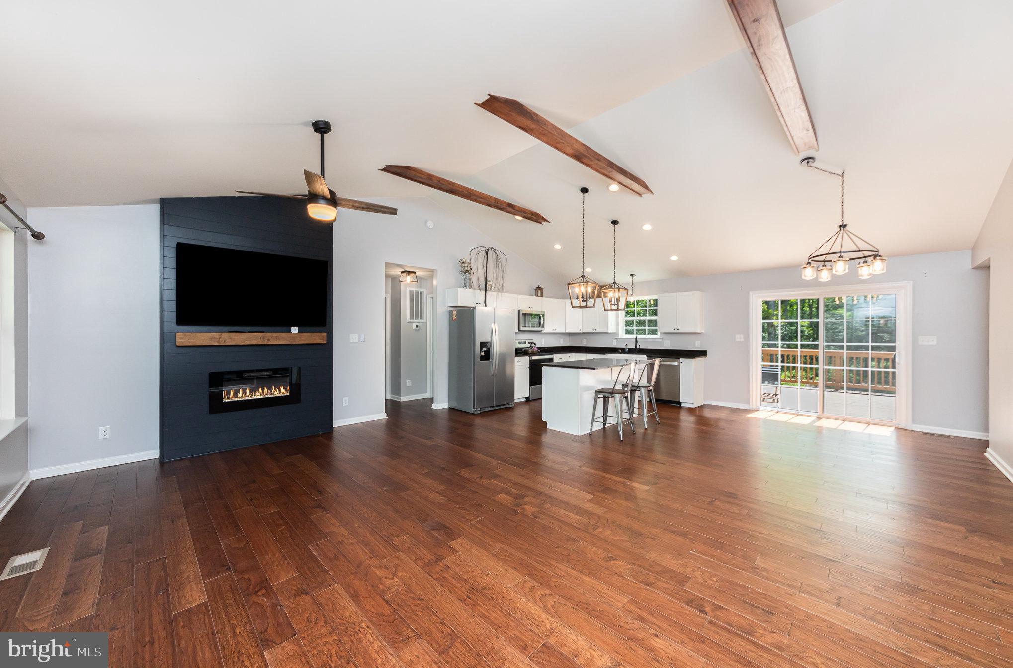 7464 Cedar Fork Road Ruther Glen, VA 22546 - Photo 4 of 24 a kitchen with stainless steel appliances a kitchen island hardwood floor sink stove and wooden floor