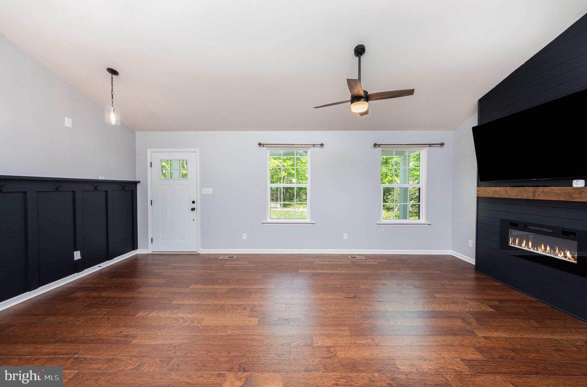 7464 Cedar Fork Road Ruther Glen, VA 22546 - Photo 5 of 24 a view of an empty room with window and wooden floor
