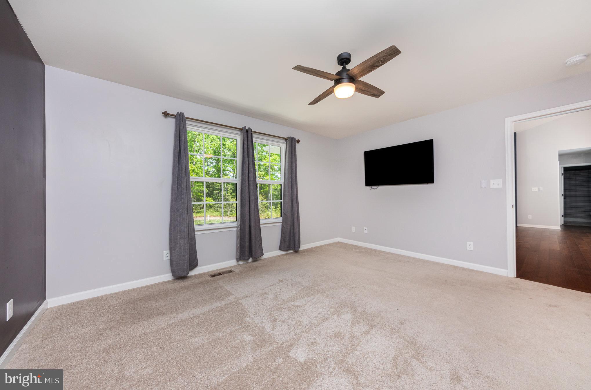 7464 Cedar Fork Road Ruther Glen, VA 22546 - Photo 8 of 24 a view of a livingroom with a ceiling fan and window