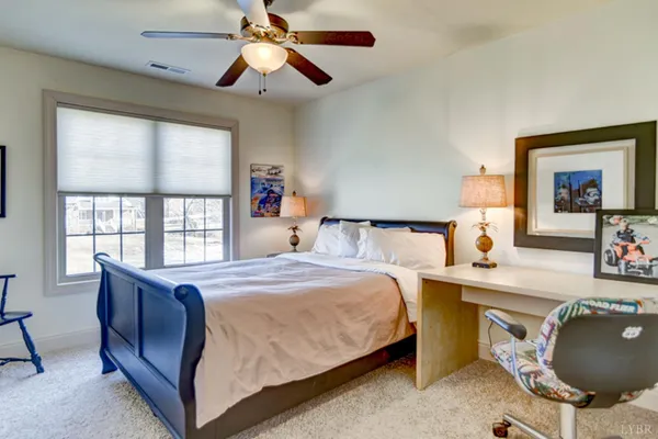 a view of a large house with a big yard and large trees