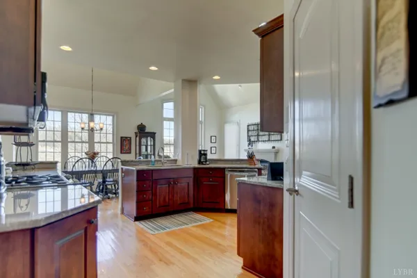 a kitchen with stainless steel appliances granite countertop a stove a sink and a microwave