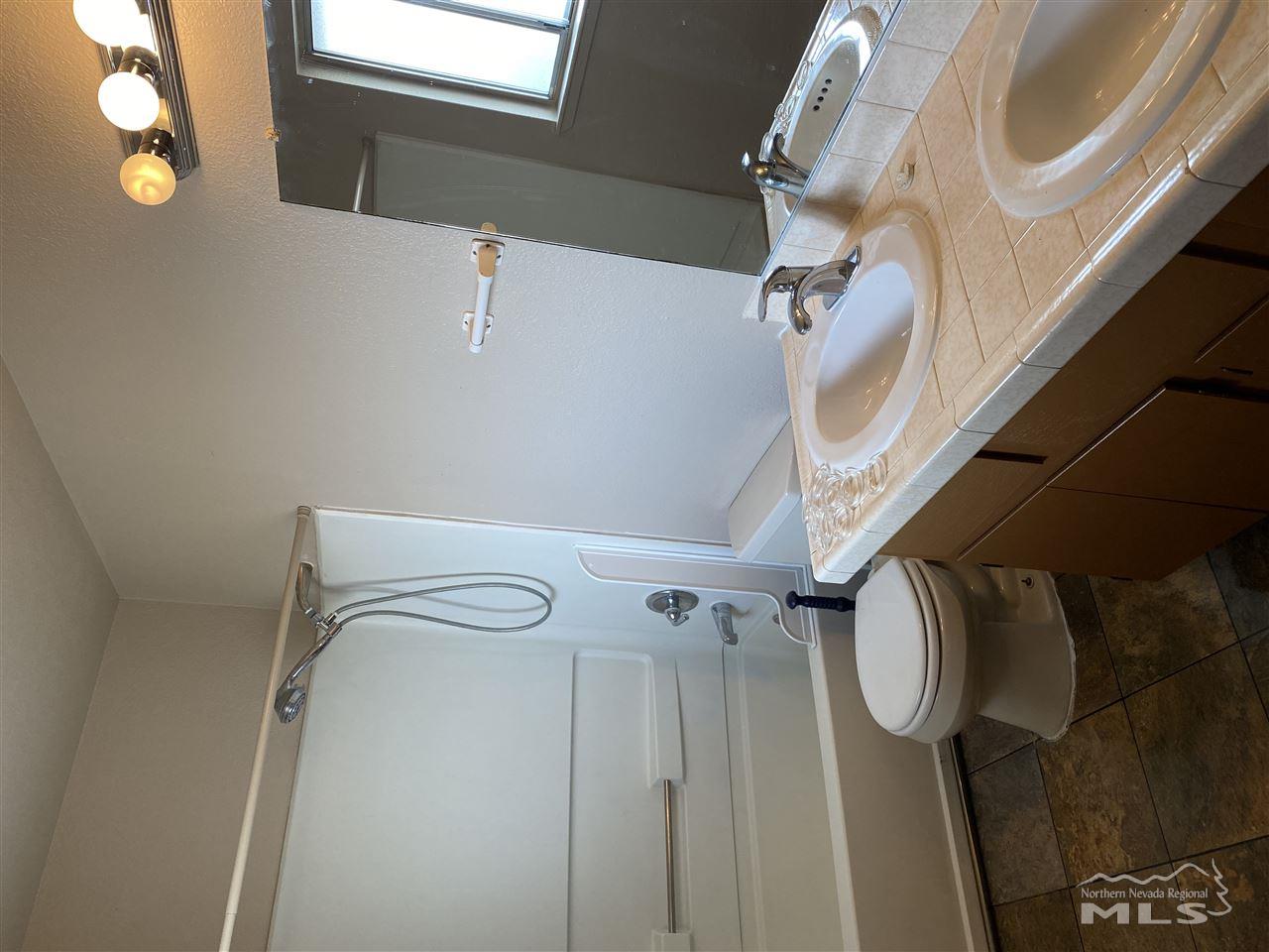 3670 Gypsum Road Reno, NV 89503 - Photo 14 of 29 a bathroom with a sink toilet and a mirror