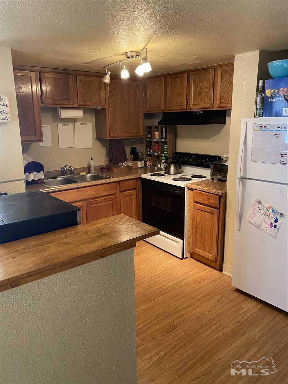 3670 Gypsum Road Reno, NV 89503 - Photo 18 of 29 a kitchen with stainless steel appliances granite countertop a stove a sink dishwasher and a refrigerator