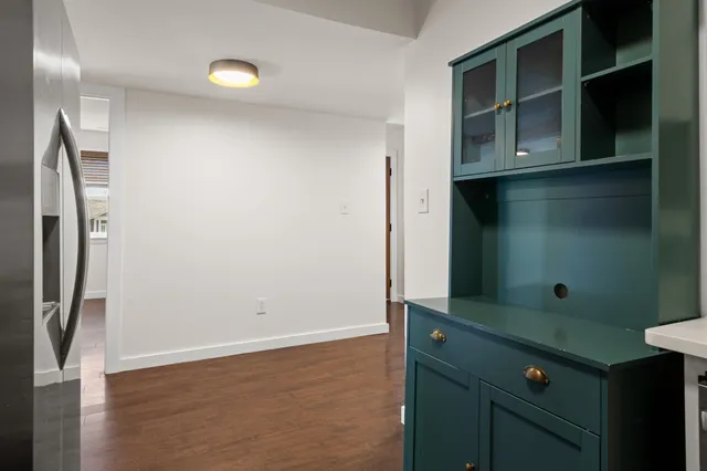 a kitchen with white cabinets and white appliances