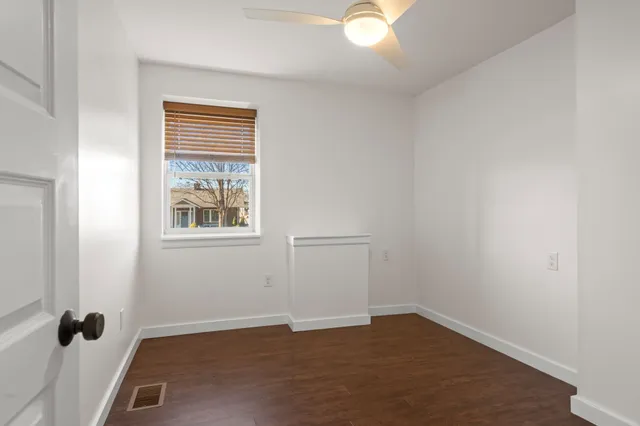 an empty room with wooden floor