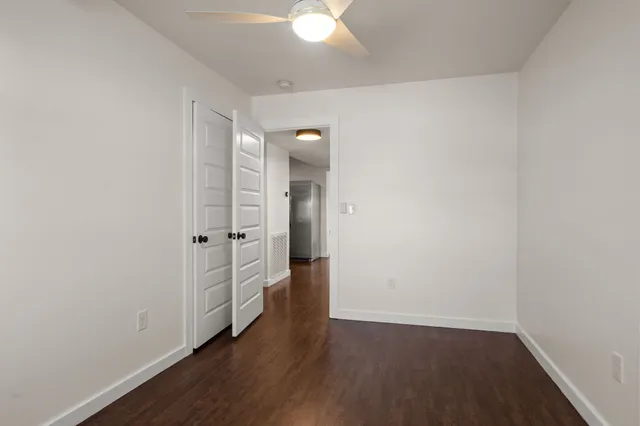 an empty room with wooden floor and a window