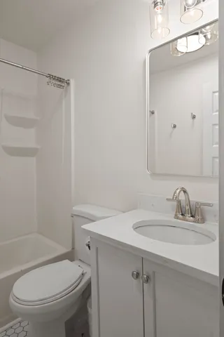 a bathroom with a toilet and a bathtub
