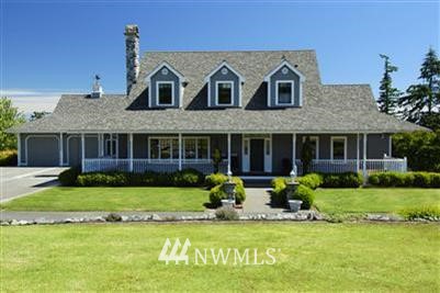 6030 South McMaster Road Freeland, WA 98249 - Photo 1 of 1 a front view of a house with a yard and porch