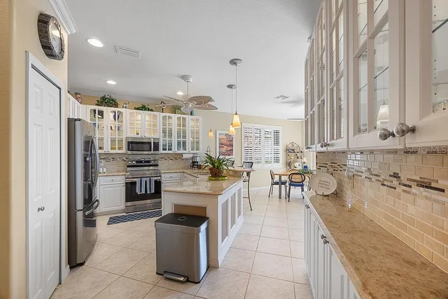 a kitchen with a refrigerator and a sink