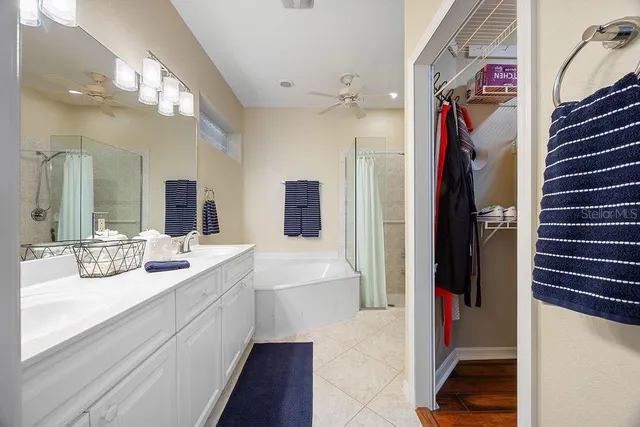 a en suite bathroom with a sink a large mirror and shower