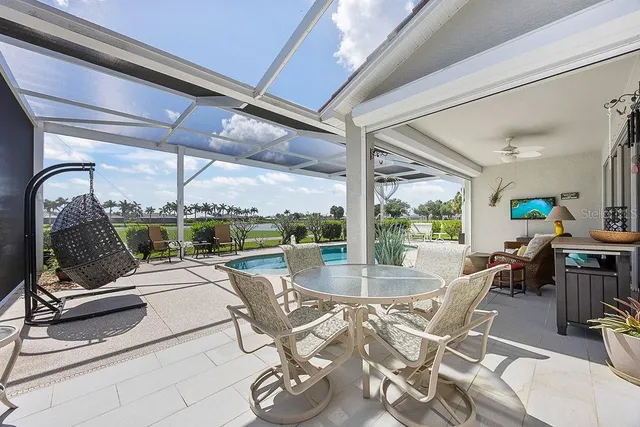 a view of a patio with dining table and chairs