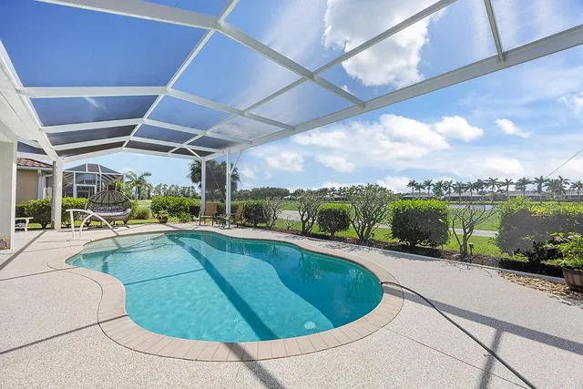 a view of a swimming pool and a back yard