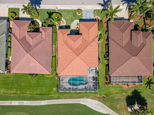 an aerial view of a house with a yard