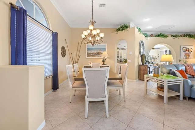 a view of a dining room with furniture and a chandelier