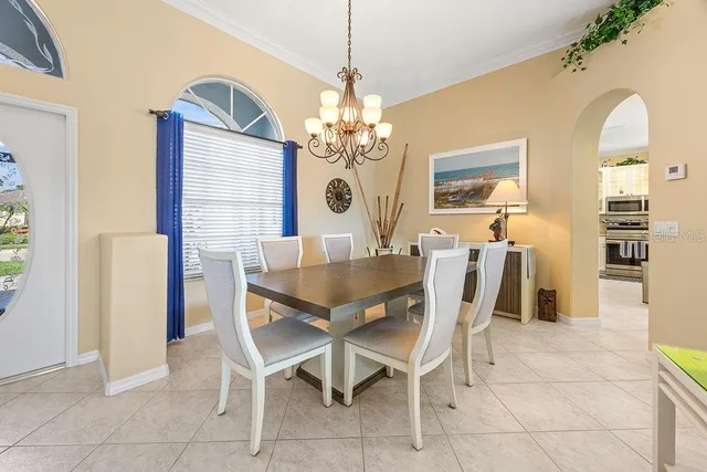 a view of a dining room with furniture and chandelier