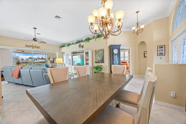 a view of a dining room with furniture a chandelier and wooden floor