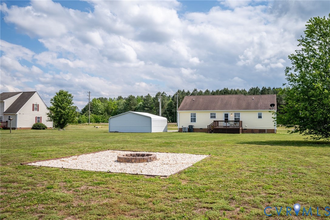 5280 West Quaker Road Disputanta, VA 23875 - Photo 12 of 33 a view of a big house with a big yard and a large trees