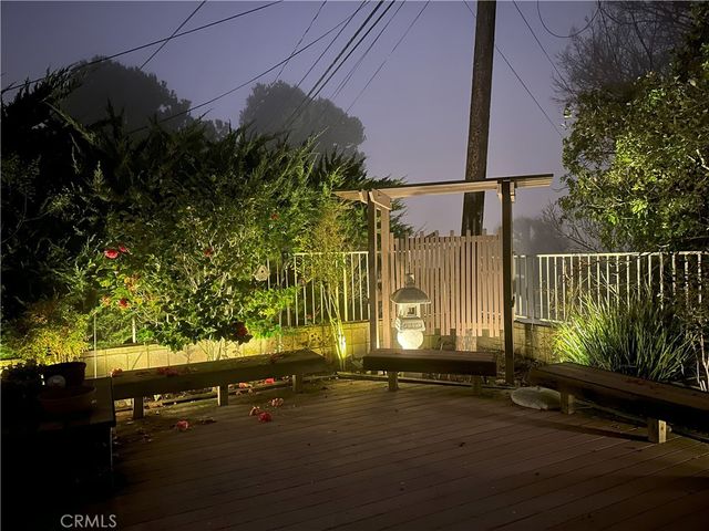 a front view of a house with a yard and outdoor seating