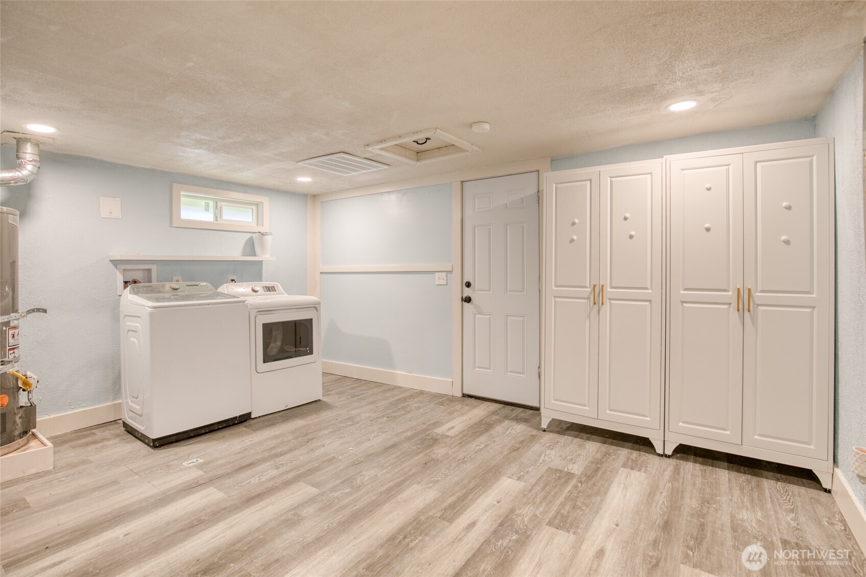 1319 West 2nd Street Aberdeen, WA 98520 - Photo 12 of 25 a view of a kitchen with a sink and dishwasher wooden floor