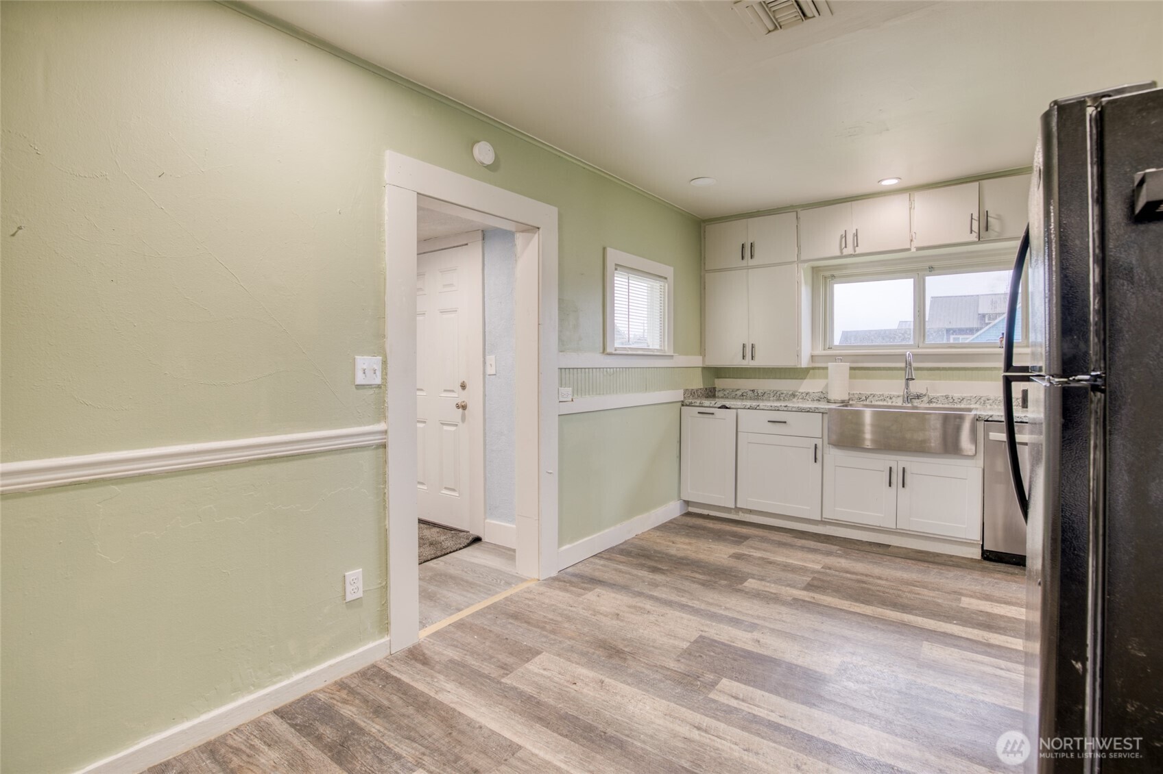 1319 West 2nd Street Aberdeen, WA 98520 - Photo 8 of 25 a kitchen with white cabinets and white appliances