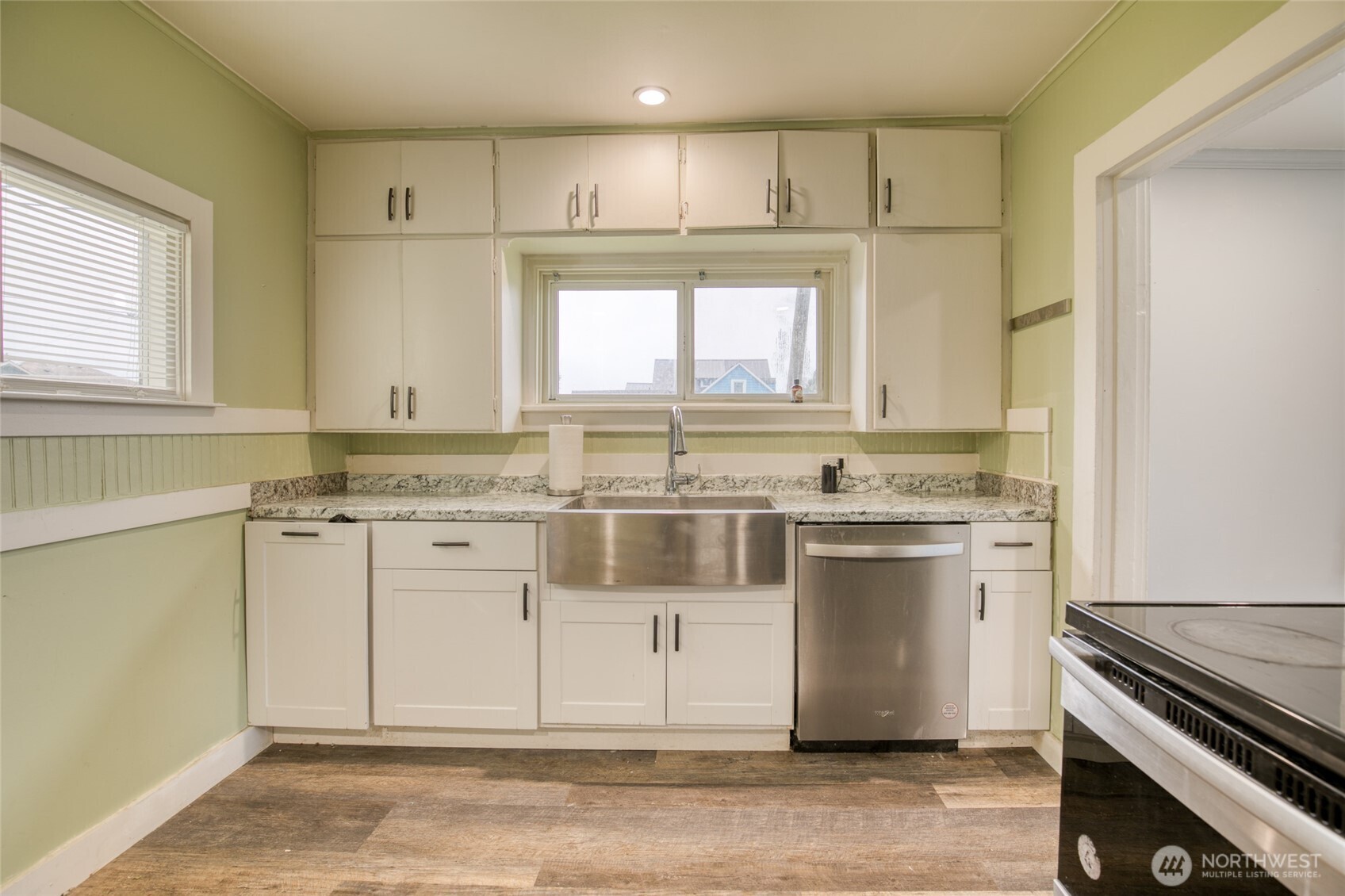 1319 West 2nd Street Aberdeen, WA 98520 - Photo 9 of 25 a kitchen with a stove window and cabinets