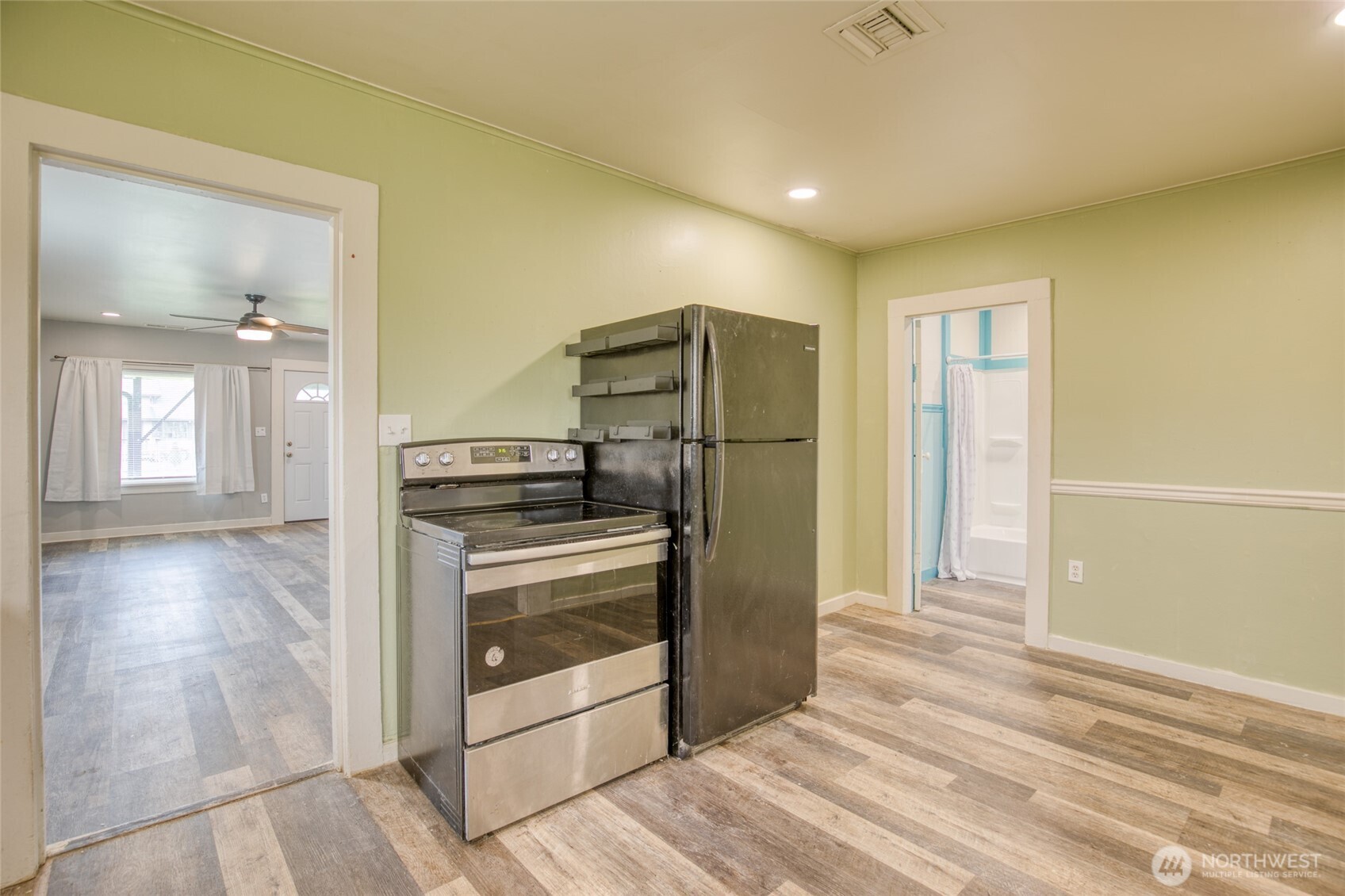 1319 West 2nd Street Aberdeen, WA 98520 - Photo 10 of 25 a open kitchen with stainless steel appliances granite countertop a refrigerator and a stove