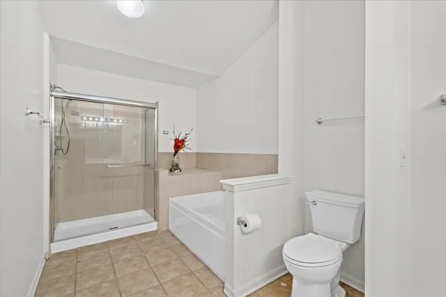 a bathroom with a granite countertop sink a toilet and shower