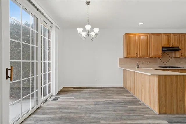 a view of kitchen with granite countertop cabinets and wooden floor