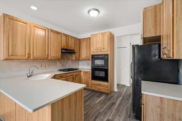 a kitchen with a refrigerator sink and microwave