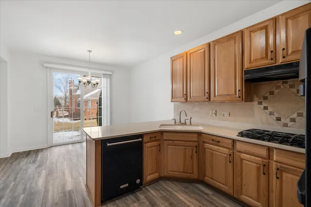 a kitchen with stainless steel appliances granite countertop a sink stove and cabinets