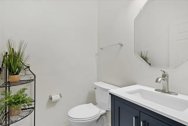 a bathroom with a sink a toilet and with mirror