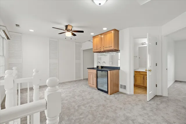a view of a kitchen with furniture and a ceiling fan