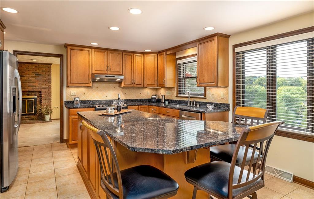104 Yorktown Road Canonsburg, PA 15317 - Photo 12 of 25 The spacious kitchen offers center island breakfast bar seating for quick meals, after school snack or a chat with the cook! The access to the family room is designed to "contain" the noise!