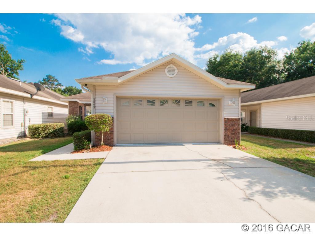 4845 Northwest 76th Road Gainesville, FL 32653 - Photo 1 of 1 a front view of a house with garden
