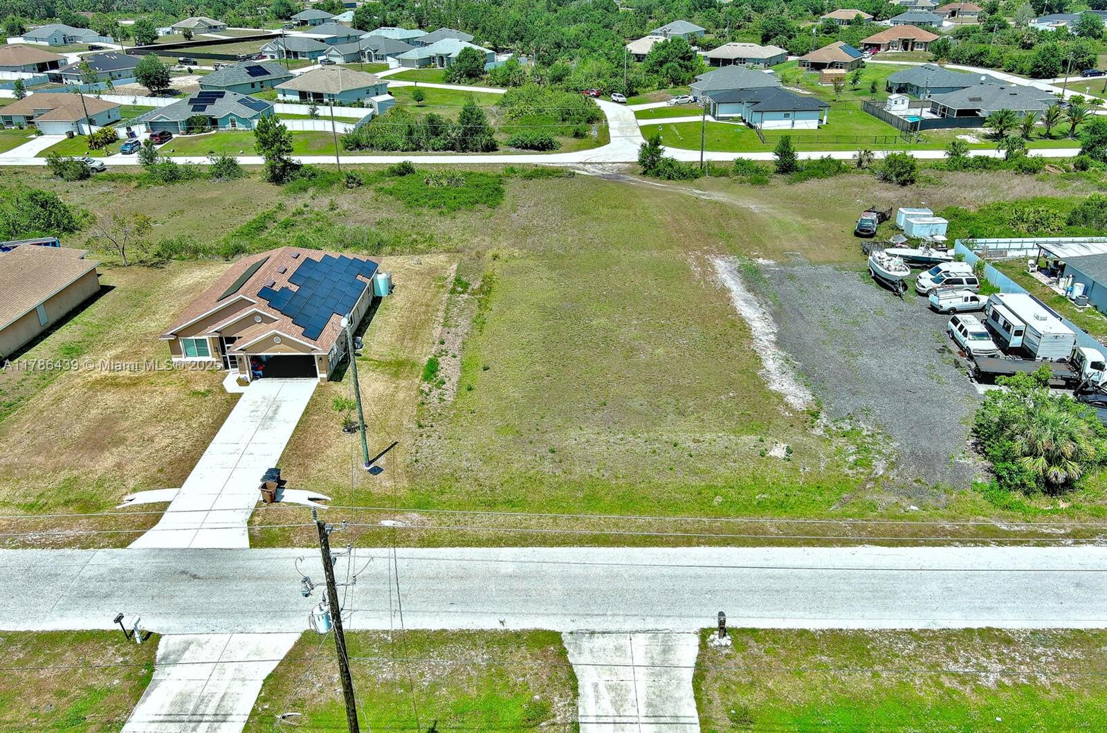 548 Windermere Drive Lehigh Acres, FL 33972 - Photo 13 of 26 an aerial view of a house with a yard