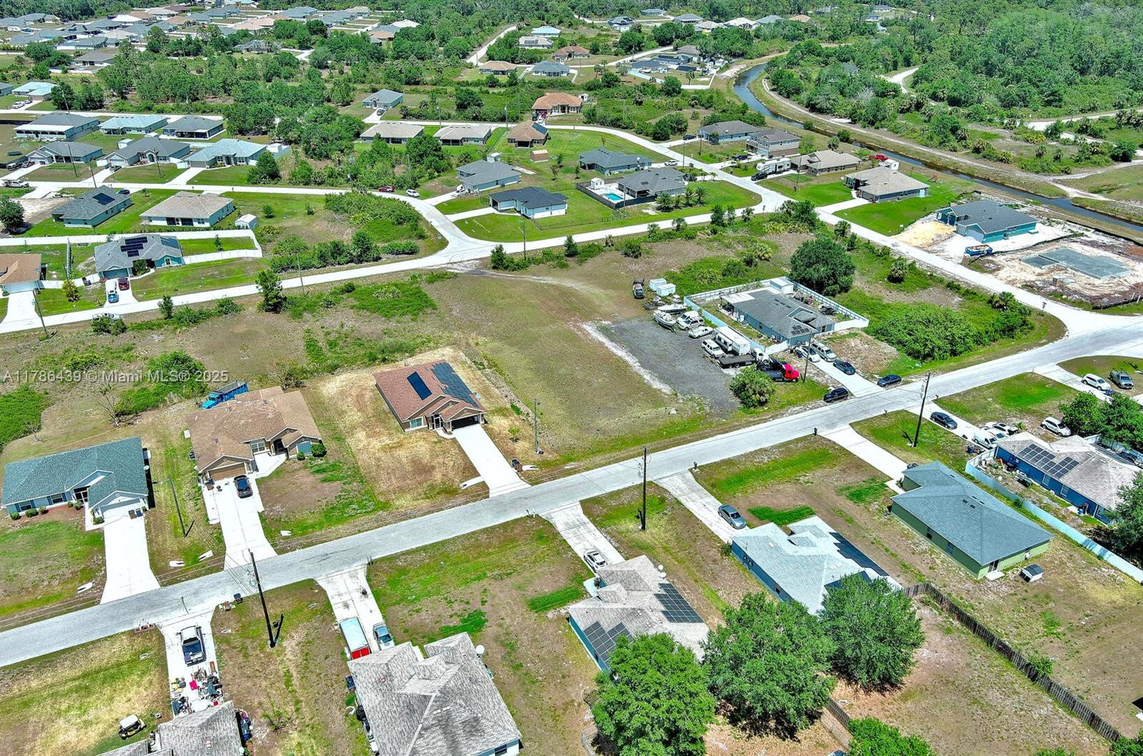 548 Windermere Drive Lehigh Acres, FL 33972 - Photo 20 of 26 an aerial view of residential houses with outdoor space