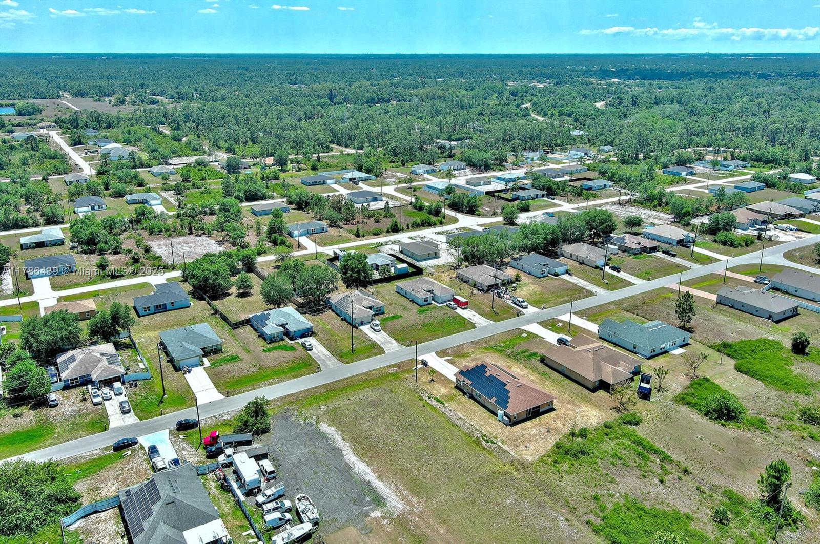 548 Windermere Drive Lehigh Acres, FL 33972 - Photo 26 of 26 an aerial view of residential houses with outdoor space and trees