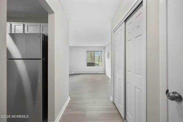 a view of a kitchen from a hallway
