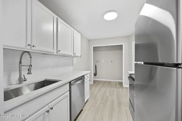 a kitchen with a sink and refrigerator