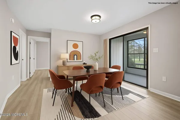 a view of a dining room with furniture and wooden floor