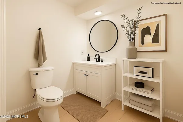 a bathroom with a toilet a sink and a mirror