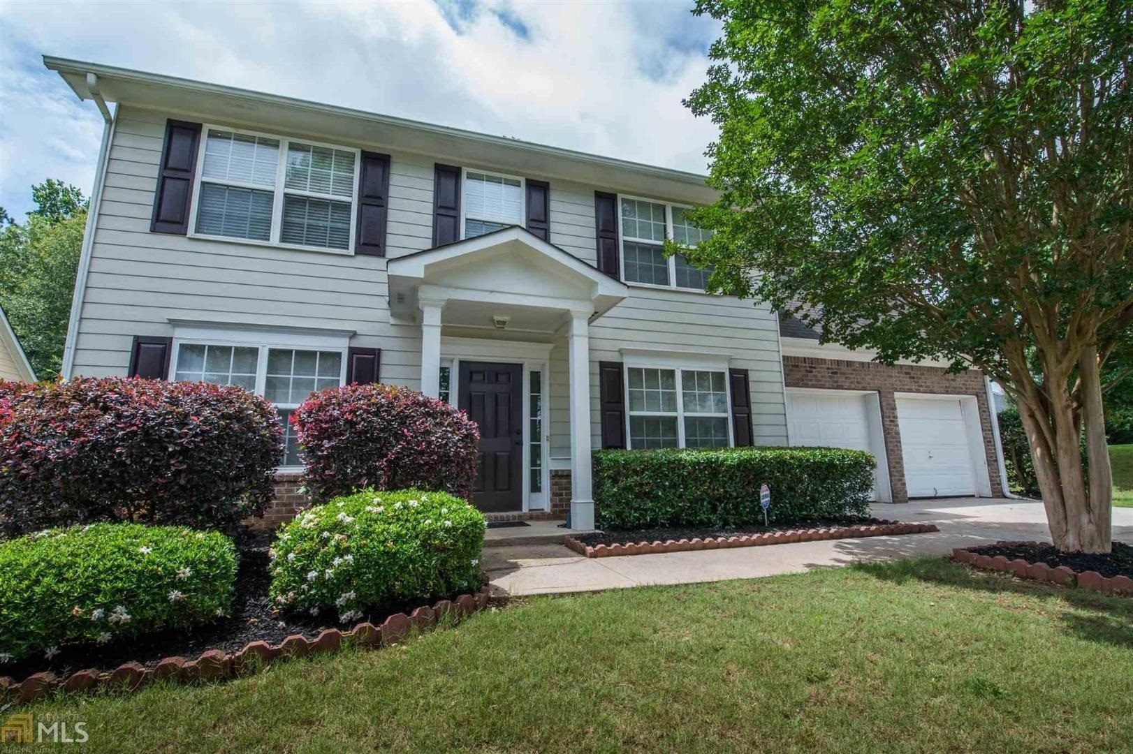 a front view of a house with a yard and porch
