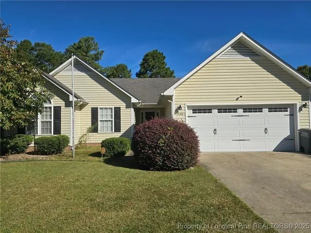 a view of a house with a yard