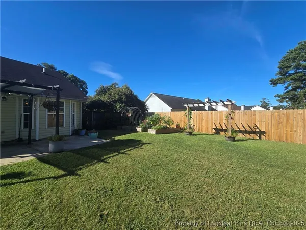 a view of a house with a yard and a garden
