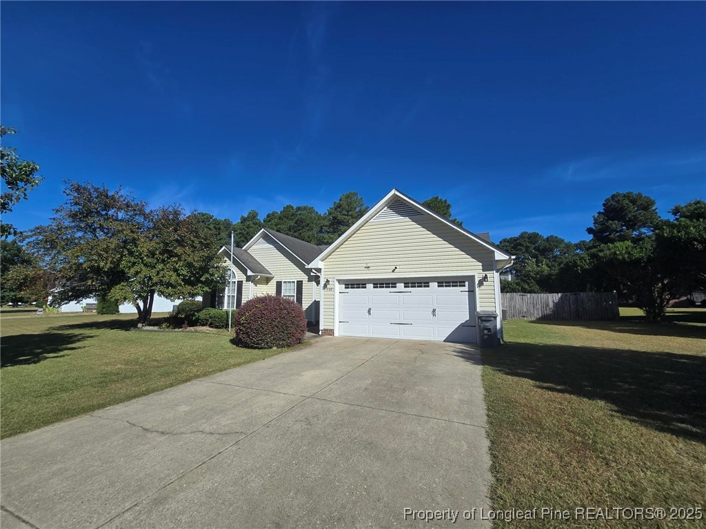 1540 Clan Campbell Drive Raeford, NC 28376 - Photo 2 of 35 a view of a house with a yard and large tree