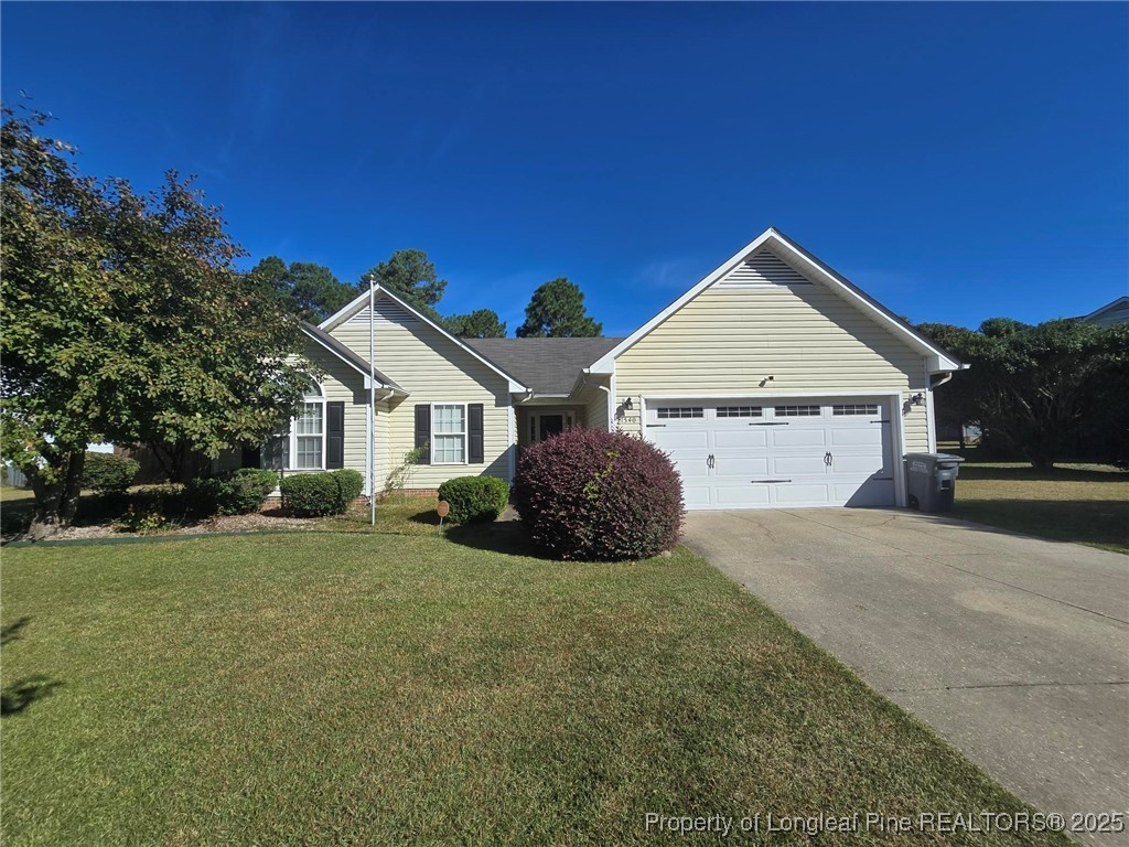 1540 Clan Campbell Drive Raeford, NC 28376 - Photo 3 of 35 a front view of a house with a yard and garage